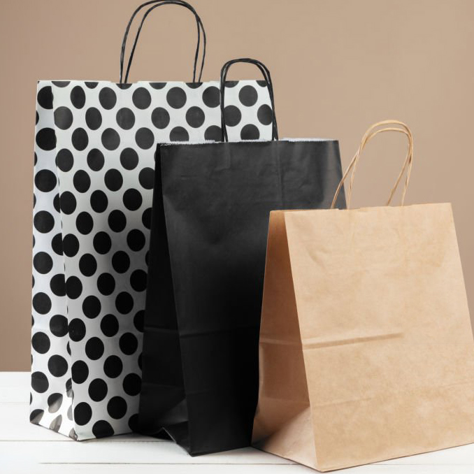 Arrangement of shopping bags on beige background